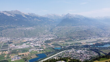 Swiss Alps in Sion region, aerial footage taken by a drone during warm summer time, clear blue skies and beautiful mountain scenery