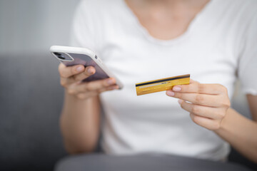 Woman holding credit card and using laptop computer for Internet online e-commerce shopping spending money Online shopping laptop technology concept . Online shopping pay by credit card concept