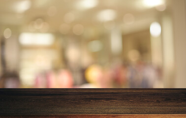 Empty wooden table in front of abstract blurred background of coffee shop . can be used for display or montage your products.Mock up for display of product