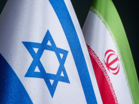 Flags of Israel and Iran, conflict between countries.