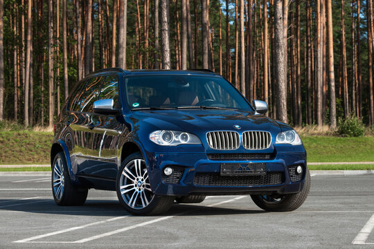 Dark blue BMW X5 (E70), 2012 year model. Sports SUV, 4.4i gasoline engine 298 kw (407 H.P.). Car on parking place, near forest. Front side view. Switzerland, Bern on SEPTEMBER 21, 2020.