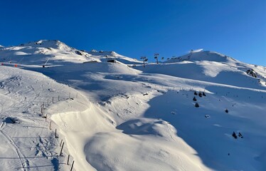 ski lift leading up the slopes of a winter sports resort in the Austrian alps
