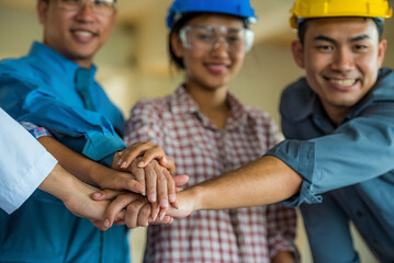 Group of Engineer United stack hands or join hand teamwork together with Spirit diversity solidarity team Partner. Joins hands together teamwork meetings empower.
