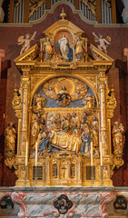 Fototapeta na wymiar LUZERN, SWITZERLAND - JUNY 24, 2022: The carved polychrome side altar of Dormition of Virgin Mary in the church St. Leodegar im Hof by Niklaus Geisler (1585-1665)