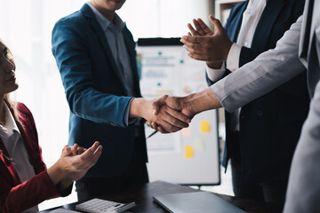 Professional businessman shaking client hand, closing successful deal.