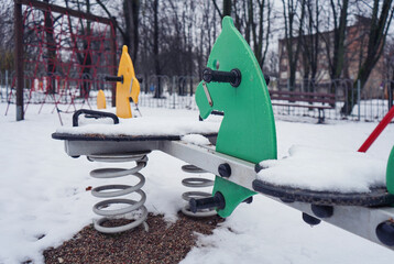 playground in winter in the snow. Sandbox in the snow, swings, gazebos in the snow