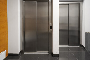 chrome elevators in multi apartment modern house. elevator breakdown. Freight elevator and normal.
