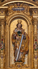Fototapeta na wymiar LUZERN, SWITZERLAND - JULY 24, 2022: The carved polychrome statue of St. Catherine in the church St. Leodegar im Hof by Niklaus Geisler (1585-1665)