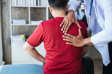 Physiotherapist massaging patient's back. A Modern rehabilitation physiotherapy worker with old man client.