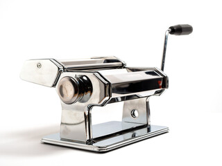 Hand machine for rolling out dough and pasta. Noodle cutter. Chrome plated steel. Anodized aluminum. White background.