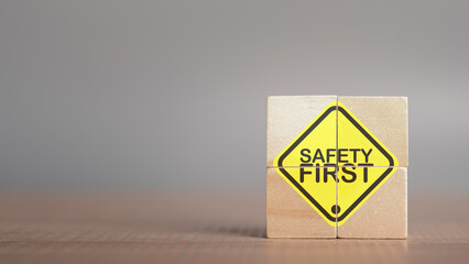 Work safety concept. Safety first text yellow in wooden cube and copy spec. Safety first sign on...