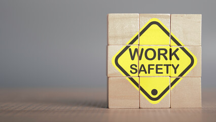 Work safety concept. Work Safety text yellow in wooden cube and copy spec. Safety first sign on virtual screen. Hazards, protections, regulations and insurance, Zero accidents, Protection dangerous.