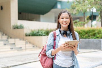 Beautiful student asian woman with backpack and books outdoor. Smile girl happy carrying a lot of book in college campus. Portrait female on international Asia University. Education, study, school..
