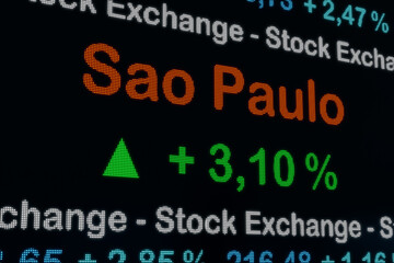 Sao Paulo stock exchange moving down. Brazil, Sao Paulo, positive stock market data on a trading screen. Green percentage sign and ticker information. Stock exchange and business. 3D illustration