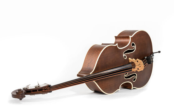 old brown double bass lies on the floor with copy-space