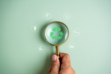 Magnifier focus to recycling icon on global earth decrease CO2 or carbon dioxide emission, carbon...