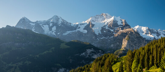 The panorama of Bernese alps with the Jungfrau, Monch and Eiger peaksin the morning light.