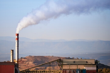 Industrial tower with polluting white smoke