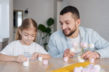 STEM education, Child learning making 3D geometric shapes, Building Structure. Child and father  building a molecule model. Kid and craft with food.