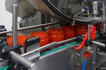 Closeup view of red caviar packaging system.