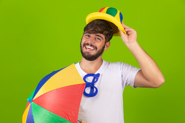 Young handsome boy dressed for carnival holding a frevo umbrella