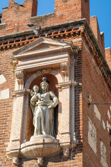 Statue depicting the Madonna and Child placed on the facade of the Domus Mercatorum Palace of Verona - Veneto region, northern Italy