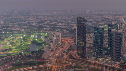 Big crossroad junction between JLT district and Dubai Marina intersected by Sheikh Zayed Road aerial day to night .