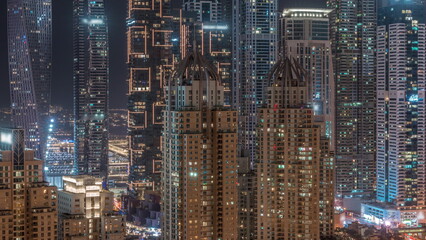 Skyscrapers of Dubai Marina with highest residential buildings all night