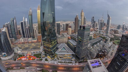 Panorama of futuristic skyscrapers in financial district business center in Dubai night to day