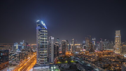 Fototapeta na wymiar Panorama showing Dubai's business bay towers aerial night . Rooftop view of some skyscrapers