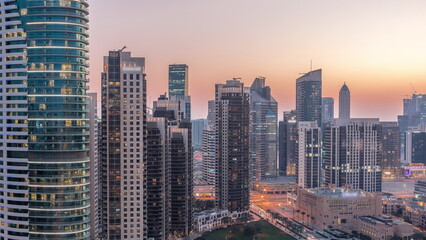 Dubai's business bay towers aerial day to night . Rooftop view of some skyscrapers