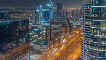 Fototapeta na wymiar Dubai's business bay towers aerial night . Rooftop view of some skyscrapers