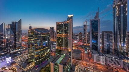 Fototapeta na wymiar Dubai international financial center skyscrapers aerial day to night .