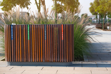 New wooden trash bins for sorting recyclables in the city park, separate waste collection