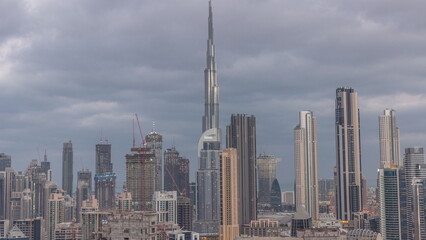 Fototapeta premium Panoramic skyline of Dubai with business bay and downtown district night to day .