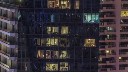 Windows lights in modern office and residential buildings at night