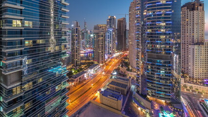 Panoramic view of the Dubai Marina and JBR area and the famous Ferris Wheel aerial day to night