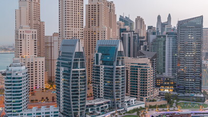 Fototapeta na wymiar Dubai Marina skyscrapers and JBR district with luxury buildings and resorts aerial night to day