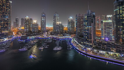 Fototapeta na wymiar Panorama showing luxury yacht bay in the city aerial night in Dubai marina