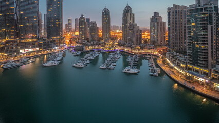 Fototapeta na wymiar Luxury yacht bay in the city aerial night to day in Dubai marina