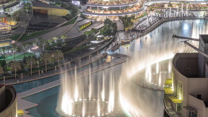 Dubai promenade singing fountains on the background of architecture aerial
