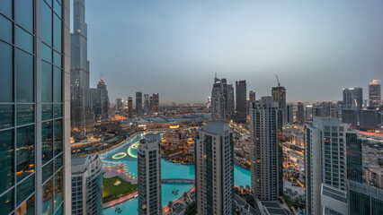 Dubai downtown with fountains and modern futuristic architecture aerial night to day