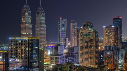 Fototapeta na wymiar Skyscrapers in Barsha Heights district and internet city towers aerial during all night .