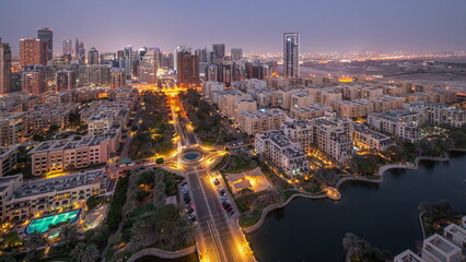 Skyscrapers in Barsha Heights district and low rise buildings in Greens district aerial day to night .