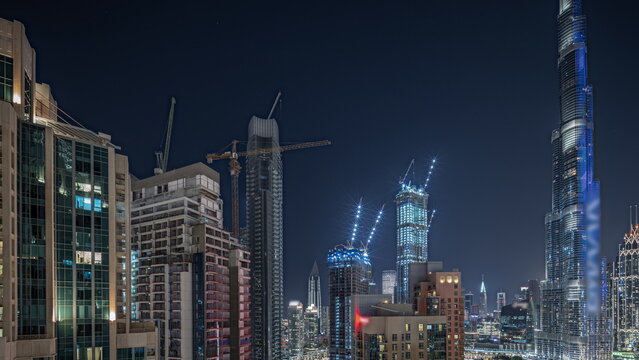 Panorama showing aerial cityscape night with illuminated architecture of Dubai downtown. © neiezhmakov