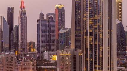 Fototapeta na wymiar Row of the tall buildings around Sheikh Zayed Road and DIFC district aerial day to night in Dubai