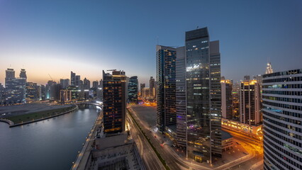 Fototapeta na wymiar Cityscape of skyscrapers in Dubai Business Bay with water canal aerial day to night