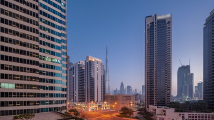 Aerial panoramic view to Dubai downtown and difc skyscrapers night to day .