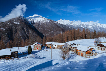 The Valtellina mountains, with its pastures, woods and fresh snow, during a wonderful winter day near the village of Sondrio, Italy - January 2023.