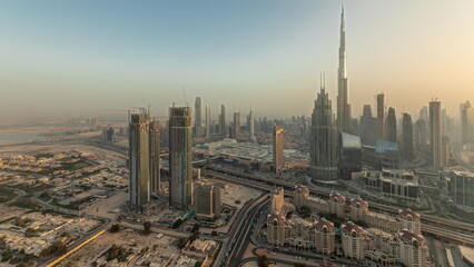 Fototapeta na wymiar Panorama showing aerial view of tallest towers in Dubai Downtown skyline and highway .